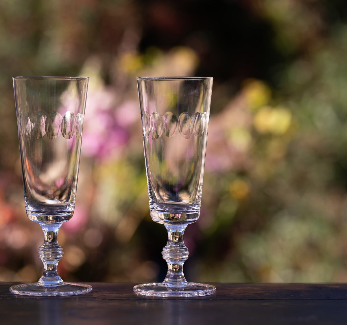 A Set of Four Crystal Champagne Flutes with Lens Design