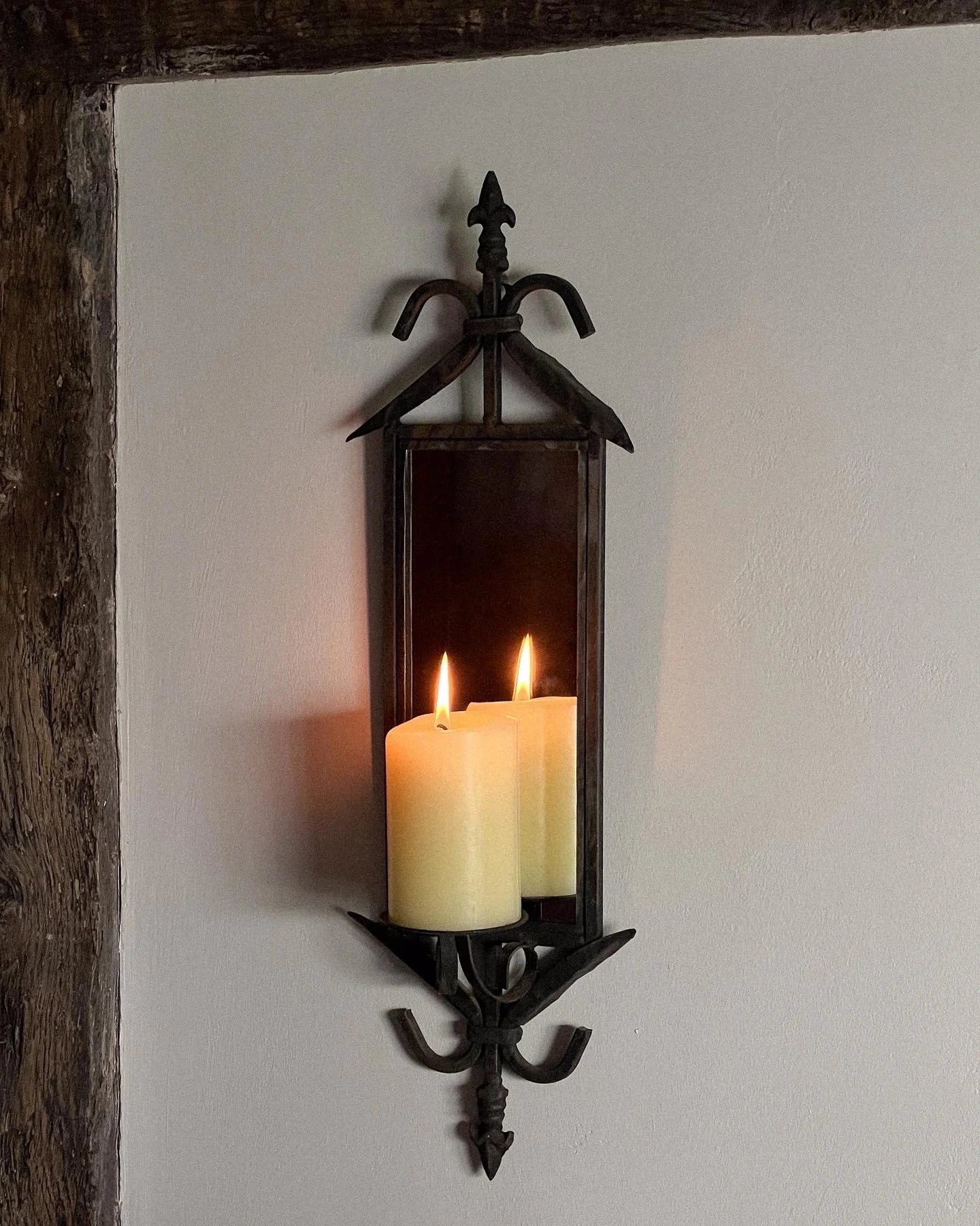 Pair of wrought iron mirrored candle sconces