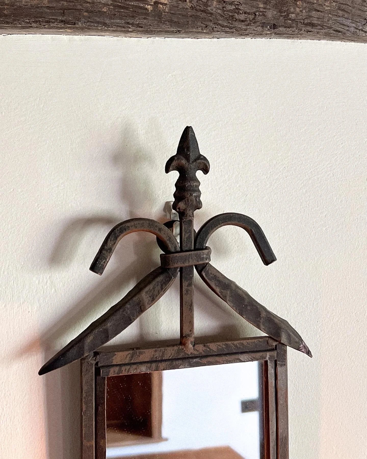 Pair of wrought iron mirrored candle sconces