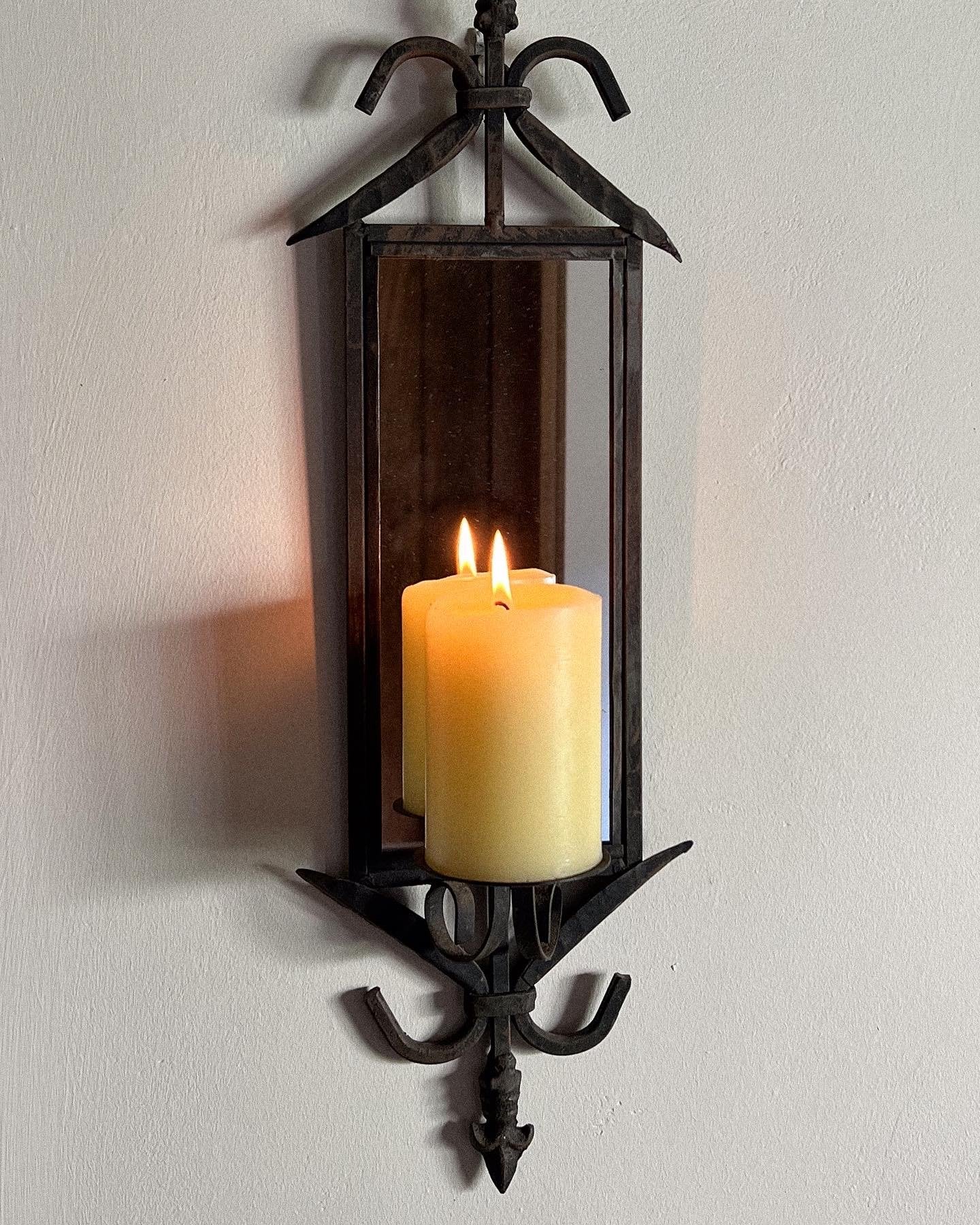 Pair of wrought iron mirrored candle sconces