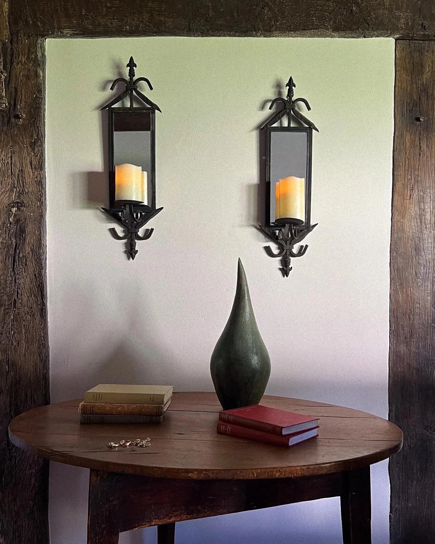 Pair of wrought iron mirrored candle sconces